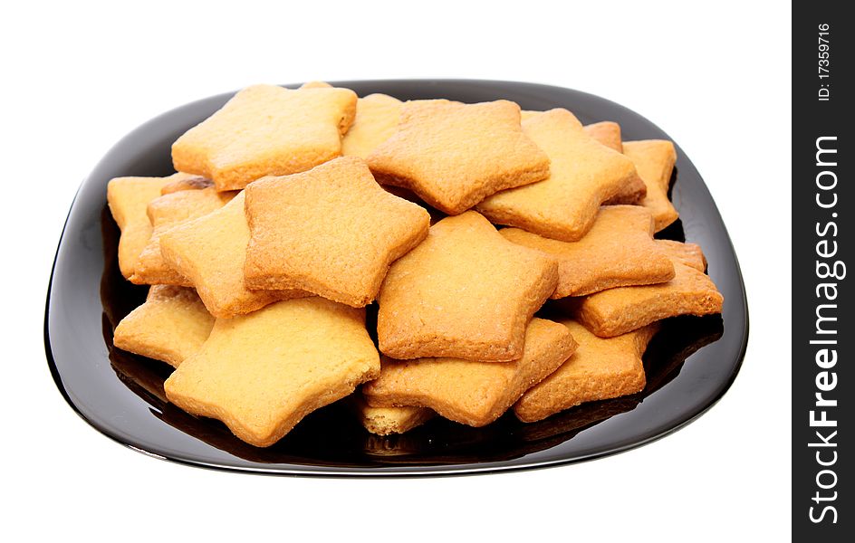 Asterisk cookies on a plate, on a white background it is isolated. Asterisk cookies on a plate, on a white background it is isolated.