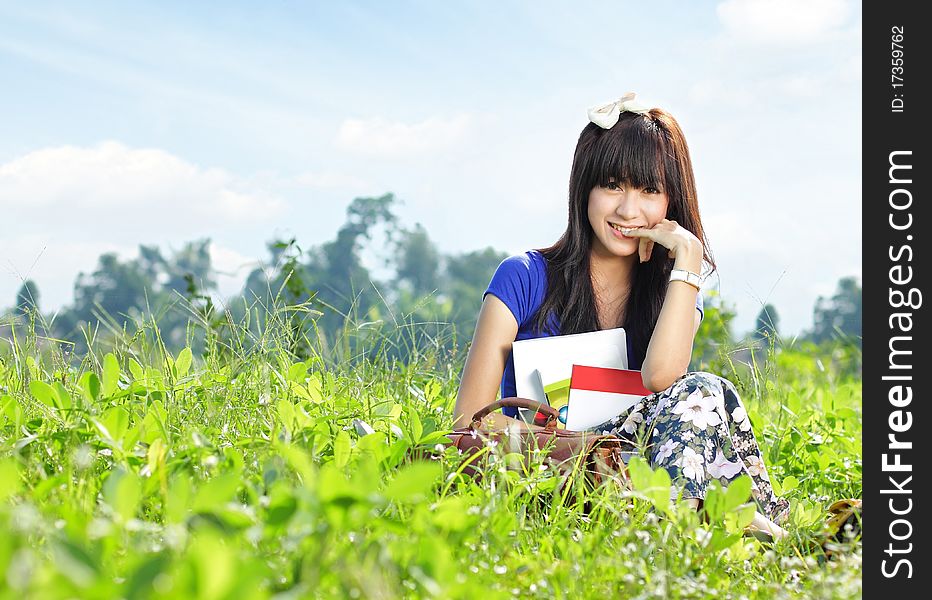 Portrait of young beautiful girl smiling with many books in her hand in beautiful sunny day. Portrait of young beautiful girl smiling with many books in her hand in beautiful sunny day