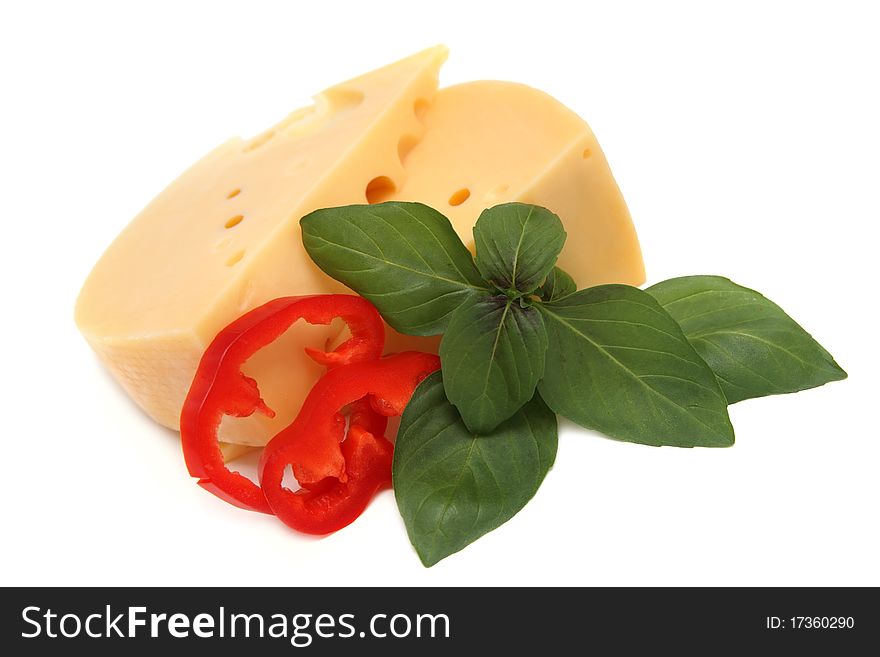 Two pieces of fresh tasty cheese with basil and red pepper. Two pieces of fresh tasty cheese with basil and red pepper