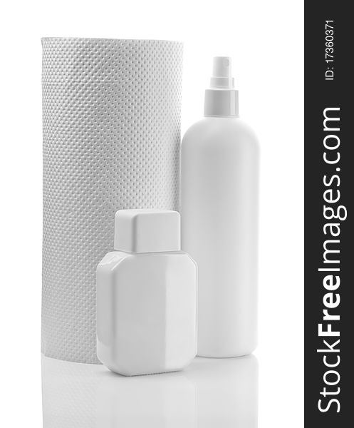 Composition of white scinkare bottles and paper towel isolated on white background. Composition of white scinkare bottles and paper towel isolated on white background
