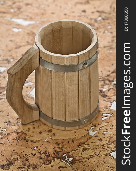 Sauna wooden mug on the background of a cork wood. Sauna wooden mug on the background of a cork wood