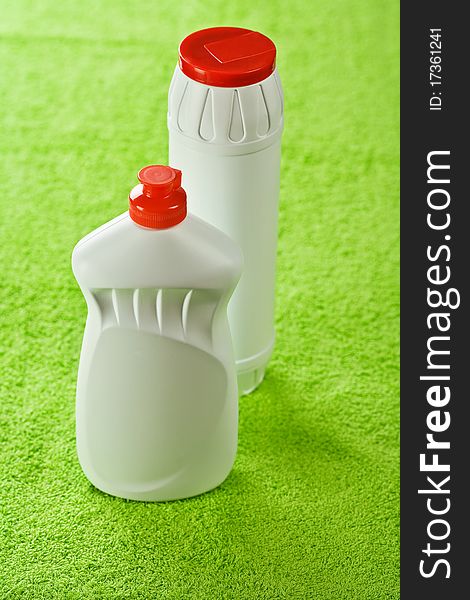 Two kitchen cleaners with red lid on green background. Two kitchen cleaners with red lid on green background
