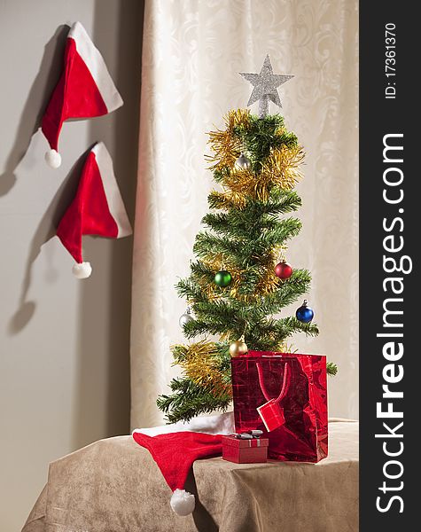Christmas tree with parephernalia of Xmas around it, in a domestic home.