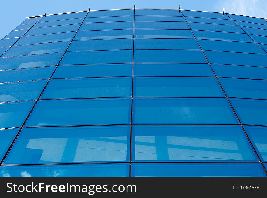 Contemporary building and blue sky. Big glass and steel wall/. Contemporary building and blue sky. Big glass and steel wall/