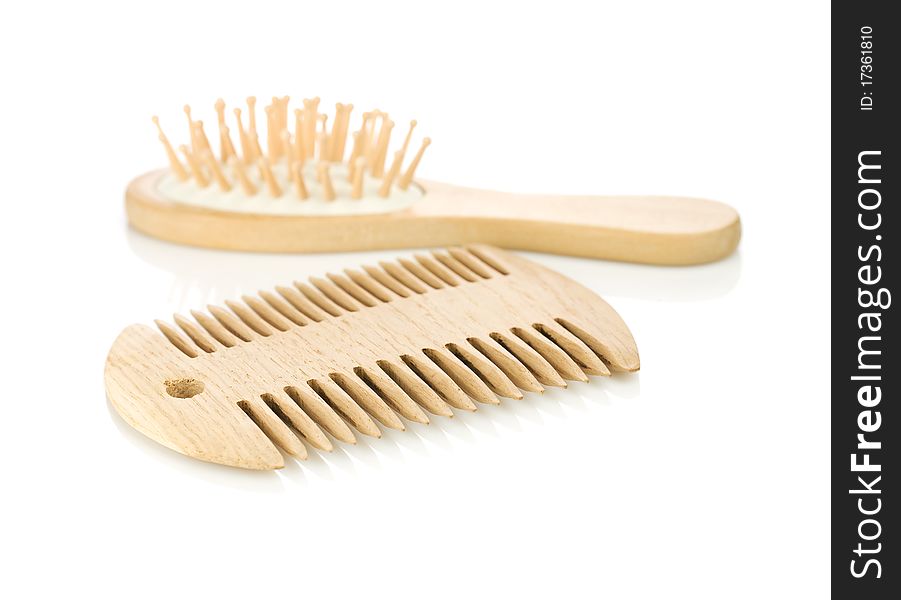 Yellow wooden double-sided comb with hairbrush isolated on white background