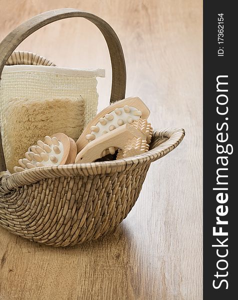 One basket with wooden accessories on wooden background. One basket with wooden accessories on wooden background