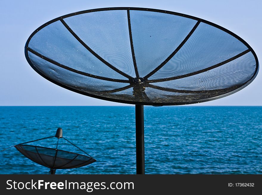 Satellite dish at the seashore.