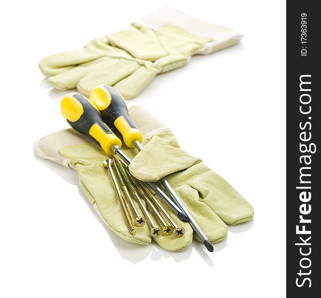 Screws and screwdrivers with gloves isolated on white background