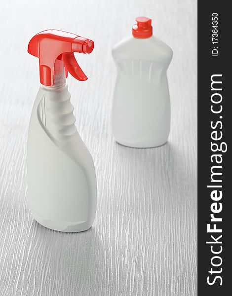 White spray cleaners on gray background. White spray cleaners on gray background