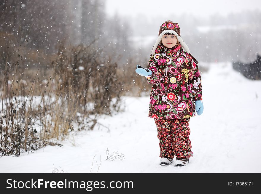 Small Girl In Strong Snow Fall