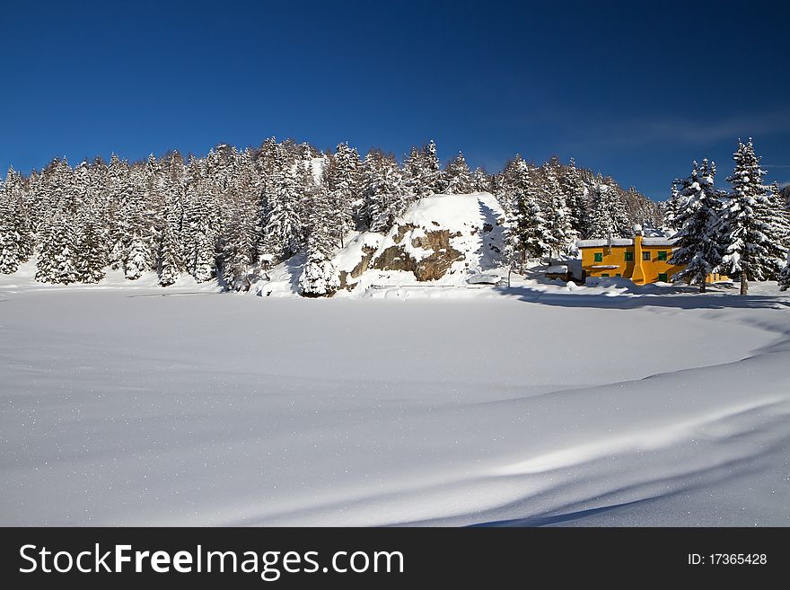 Trivigno mountain dew at 2000 meters on the sea-level. During winter the lake in front to the dew is icy and under snow. Brixia province, Lombardy region, Italy. Trivigno mountain dew at 2000 meters on the sea-level. During winter the lake in front to the dew is icy and under snow. Brixia province, Lombardy region, Italy