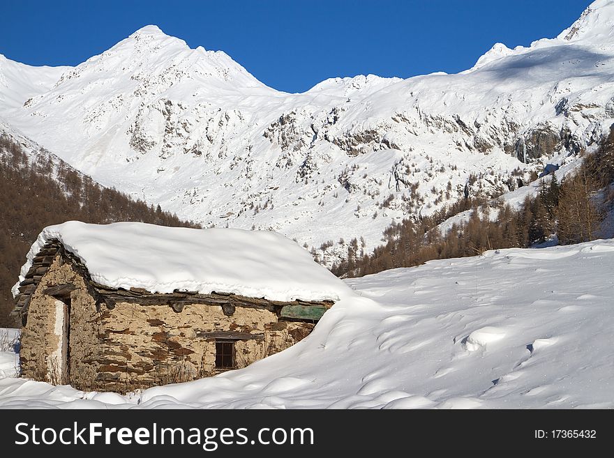 Cabins in a mountain valley in the North of Italy during winter. Brixia province, Lombardy region, Italy. Cabins in a mountain valley in the North of Italy during winter. Brixia province, Lombardy region, Italy