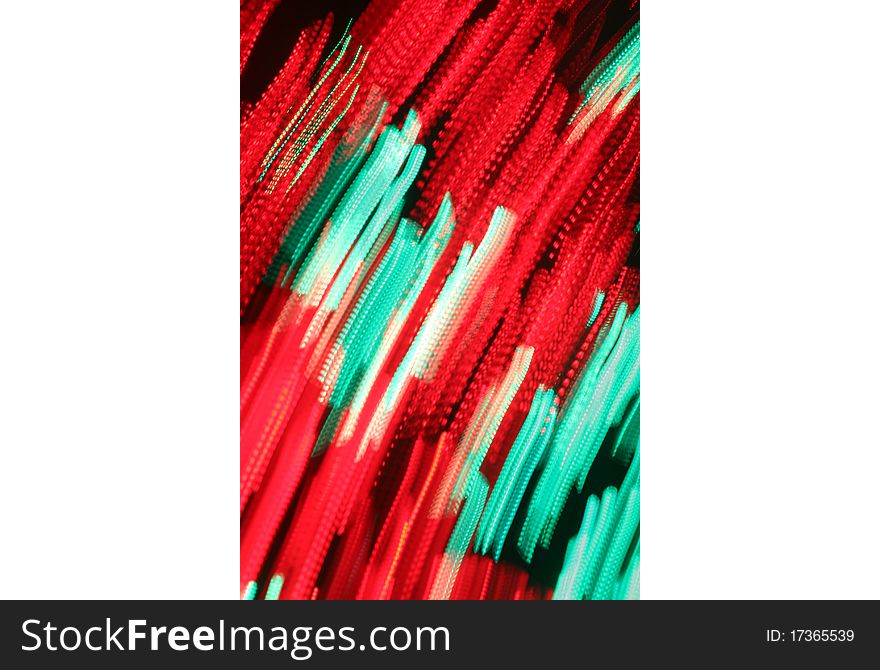 Blur of red and green lights moving diagonally against a black background. Blur of red and green lights moving diagonally against a black background.