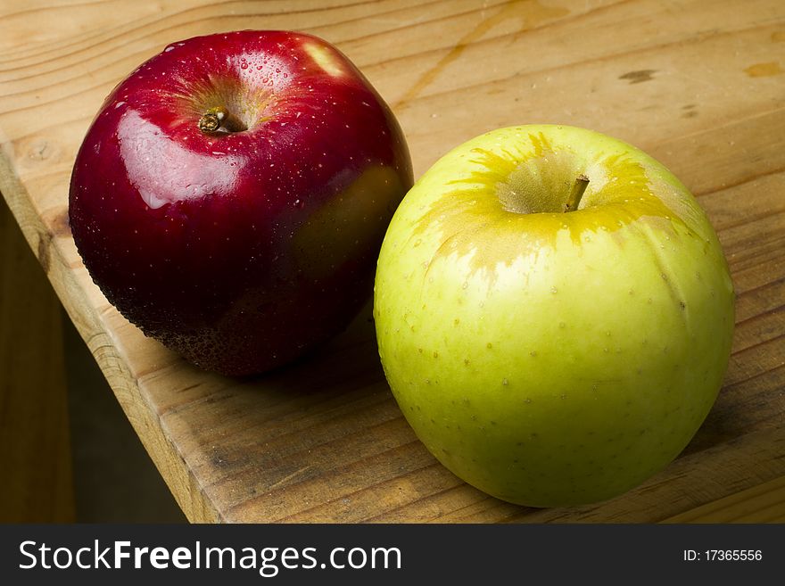 Fresh organic red and green apples on a wooden table