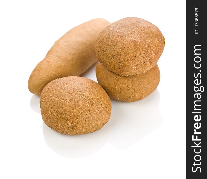 One long and three round loafs of bread isolated on white background