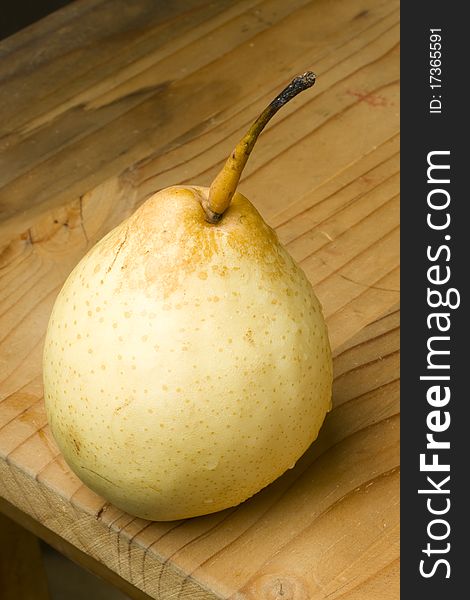 Fresh organic white pear fruit on a wooden farmers table. Fresh organic white pear fruit on a wooden farmers table