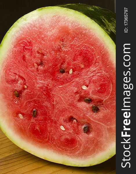 A freshly cut water melon on a wooden table