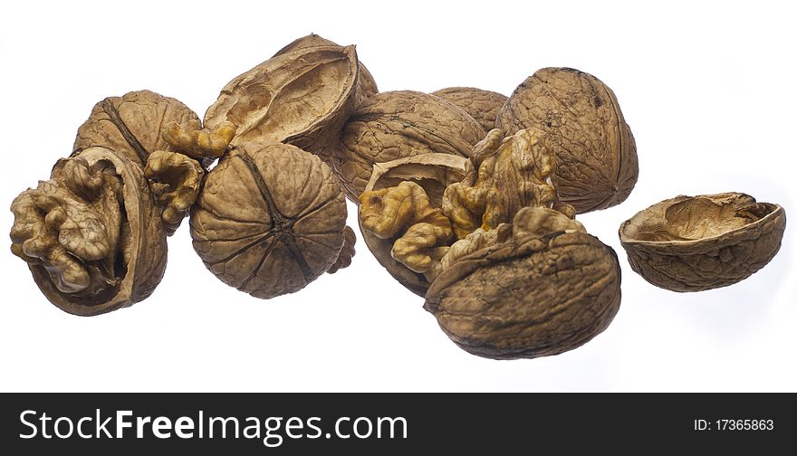 Whole walnuts and cracked walnuts on a white background. Whole walnuts and cracked walnuts on a white background