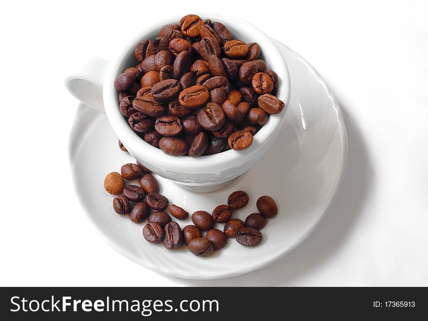 Coffee cup and coffee beans on white background