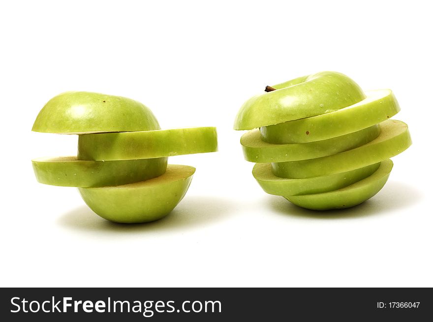 Green sliced apples isolated on white background