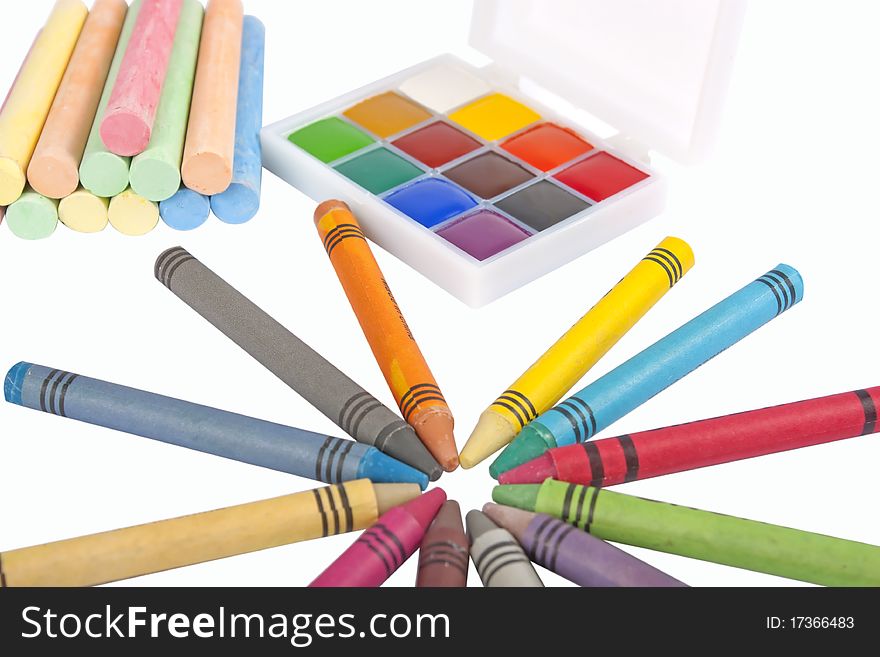 Colored wax pencils, chalk and a watercolor isolated on a on white background with clipping path