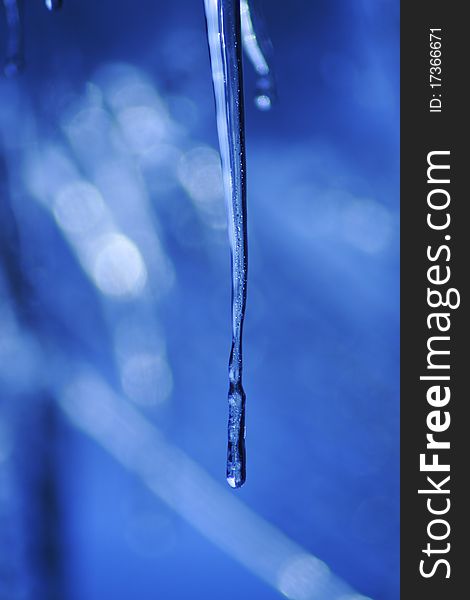 Icicle coming down from our roof. The blurred background is the sky. December 2010. Icicle coming down from our roof. The blurred background is the sky. December 2010