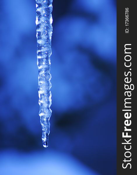 Icicle coming down from our roof. The blurred background is the sky. December 2010. Icicle coming down from our roof. The blurred background is the sky. December 2010