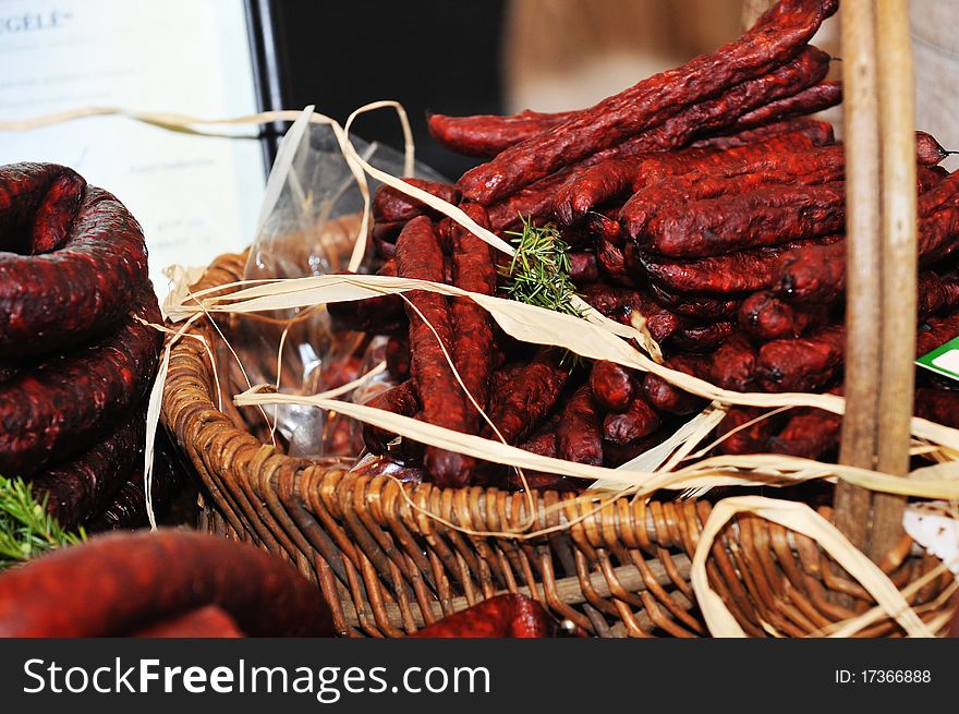 Selection of cold meat (ham smoked, sirloin, headcheese, sausages, hot dogs) at outdoor market