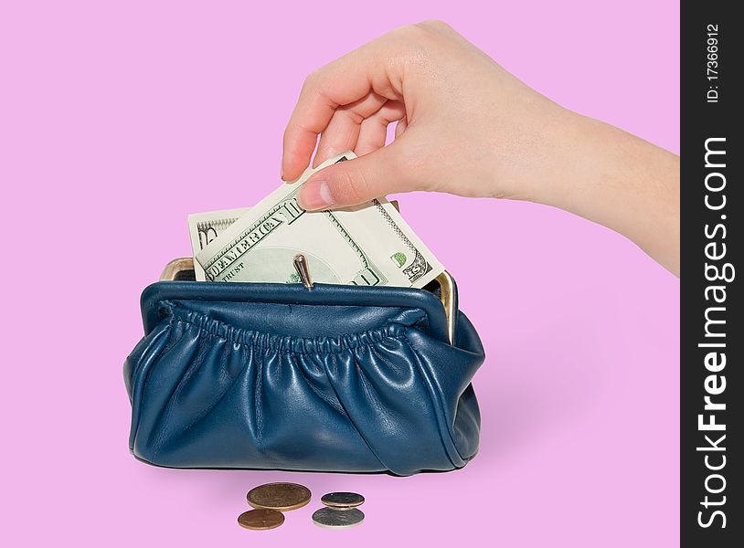 Female hand puts money into the wallet