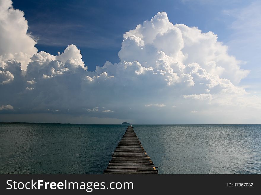 Ocean Pier extending out with stunning cloudy Sky. Ocean Pier extending out with stunning cloudy Sky