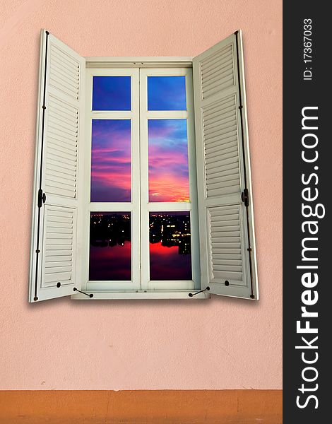 Sunset view from white wooden window on pink wall