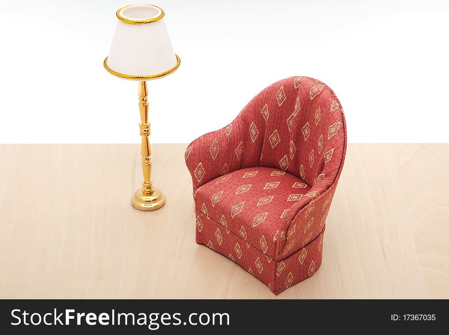 Armchair with lamp, furniture on wooden floor against white background