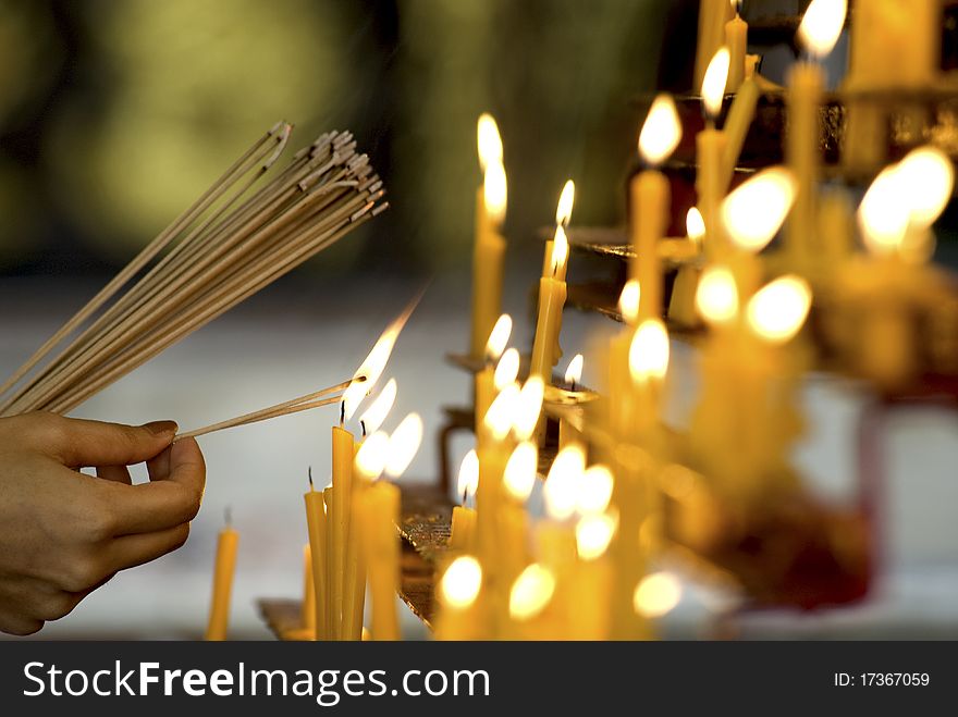 Burn joss sticks from candle in temple. Burn joss sticks from candle in temple.