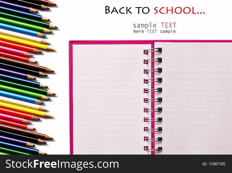 Set of pink notebook and color pencils isolated on white