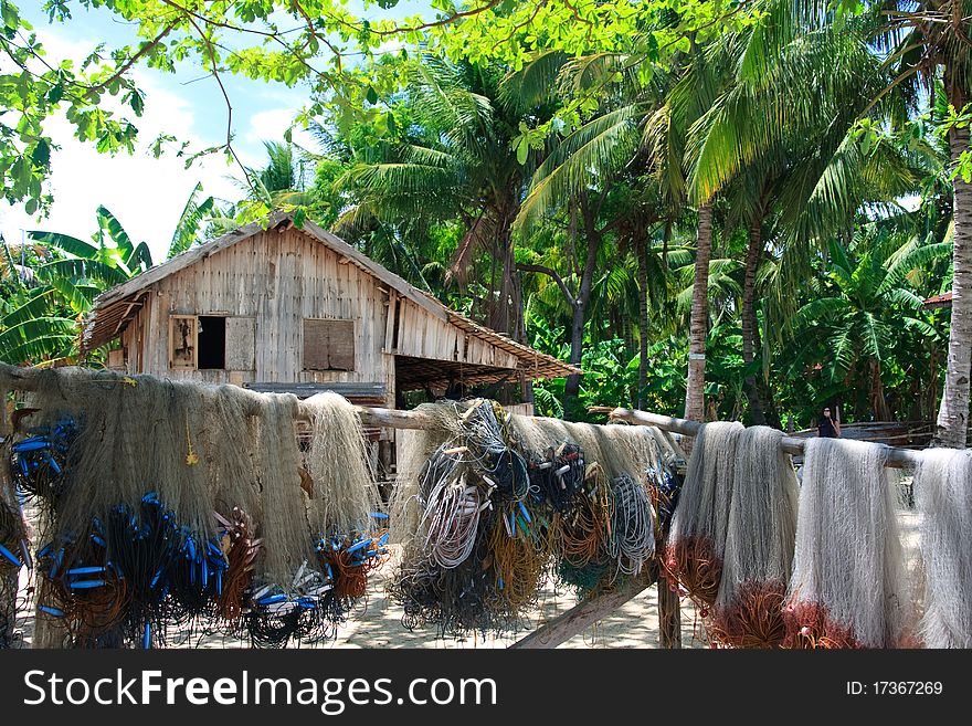 Tropical island hut with hanging fishing nets. Tropical island hut with hanging fishing nets
