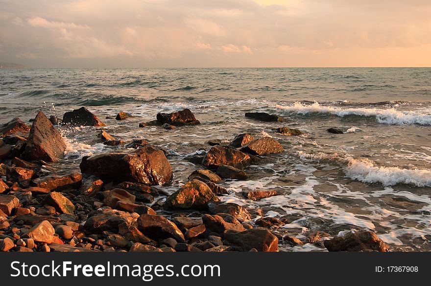 Beautiful sight of a stony seashore before sunset