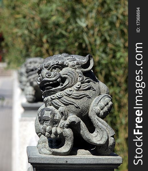 Row of stone Chinese lion statue