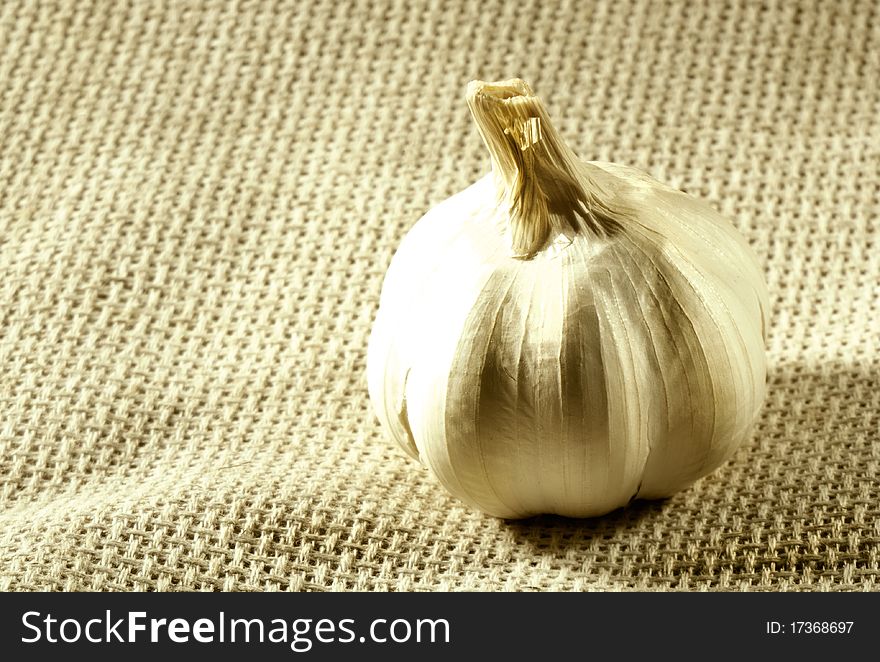 Garlic and clove over hessian background. shot with view camera