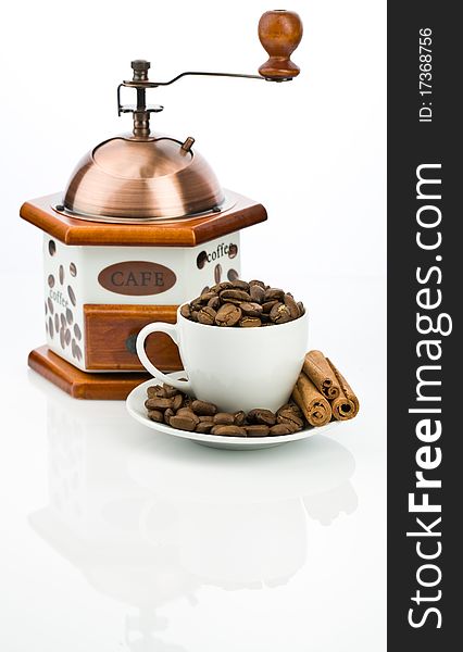 Studio shot coffe mill and cup with beans isolated on white background