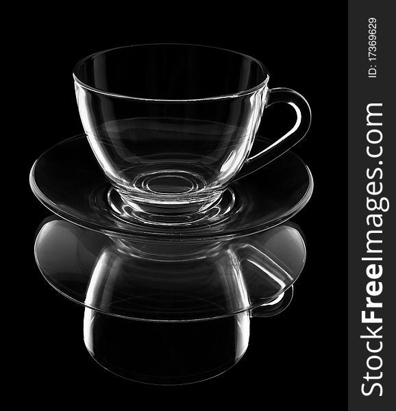 Transparent cup on a plate with reflection it is isolated. Transparent cup on a plate with reflection it is isolated