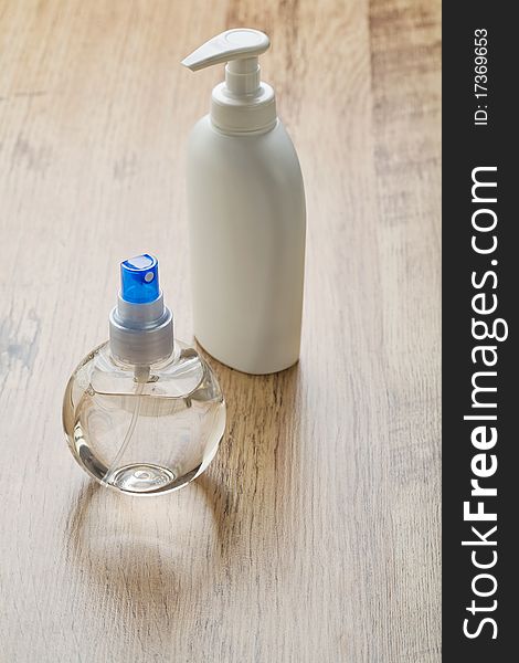 White and transparent bottles on wooden background