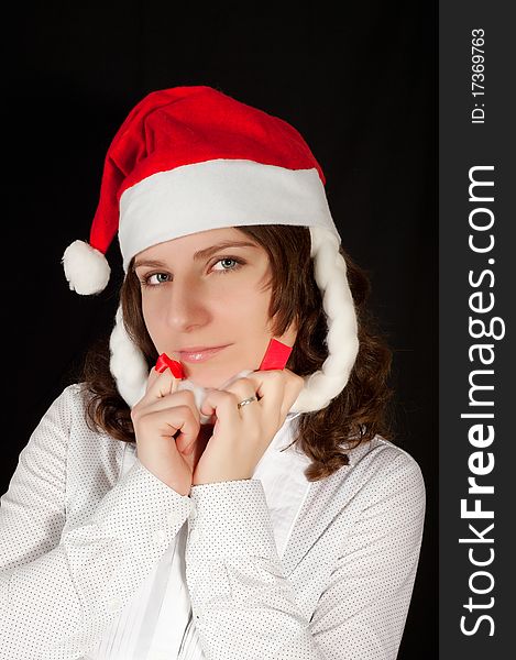 Beautiful young woman in red wearing santa hat. Isolated on white background.