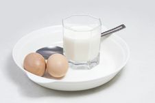 A Glass Of Milk And Two Eggs Royalty Free Stock Photography