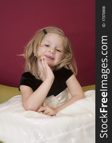 Beautiful young girl posing for the camera on couch. Beautiful young girl posing for the camera on couch