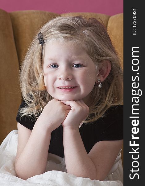 Big smile on beautiful young girl sitting on chair. Big smile on beautiful young girl sitting on chair