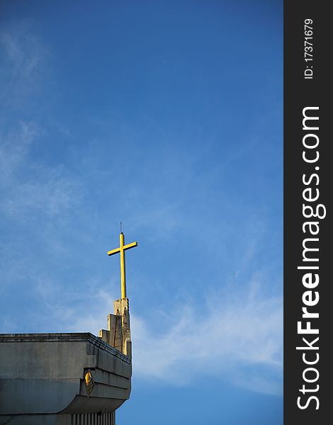 Church and cross in blue sky