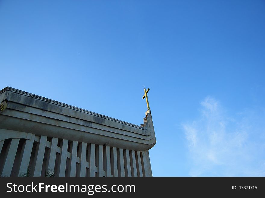 Church and cross in blue sky