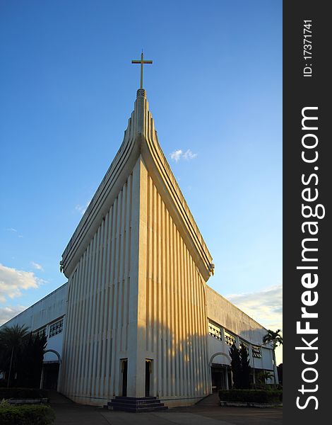 Church and cross in blue sky