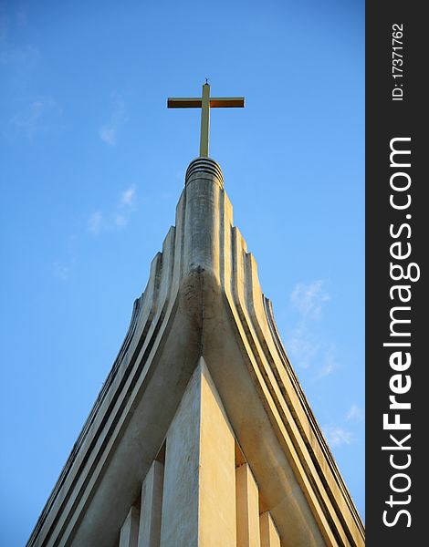 Church and cross in blue sky