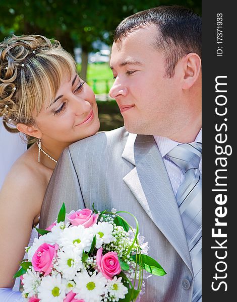 Outdoor day shot close up portrait of bride and groom. Outdoor day shot close up portrait of bride and groom